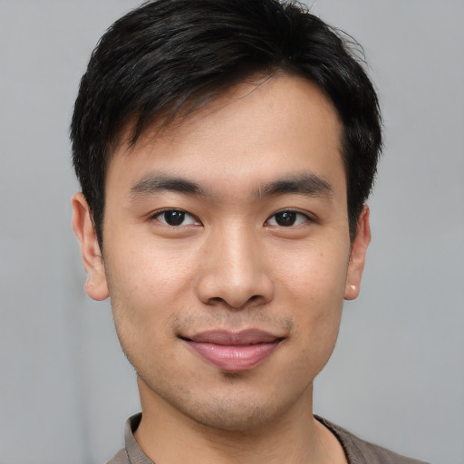 Joyful white young-adult male with short  black hair and brown eyes