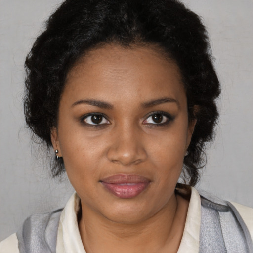 Joyful black young-adult female with short  brown hair and brown eyes