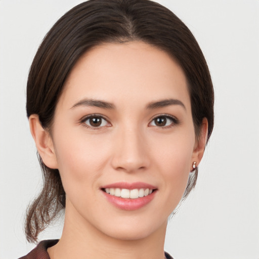 Joyful white young-adult female with medium  brown hair and brown eyes