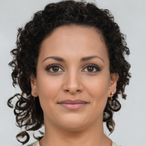 Joyful latino young-adult female with long  brown hair and brown eyes