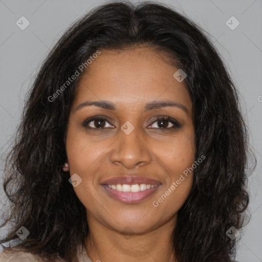 Joyful black young-adult female with long  brown hair and brown eyes