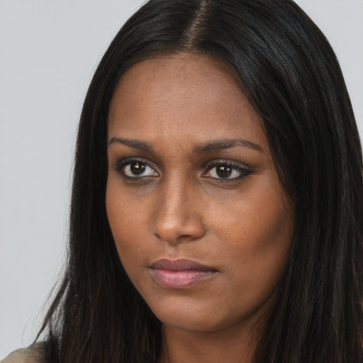 Neutral black young-adult female with long  brown hair and brown eyes