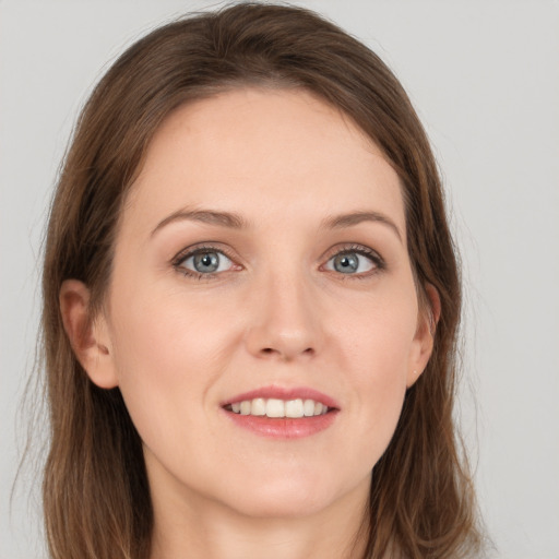 Joyful white young-adult female with long  brown hair and grey eyes