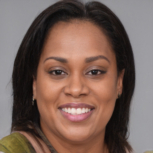 Joyful black adult female with medium  brown hair and brown eyes