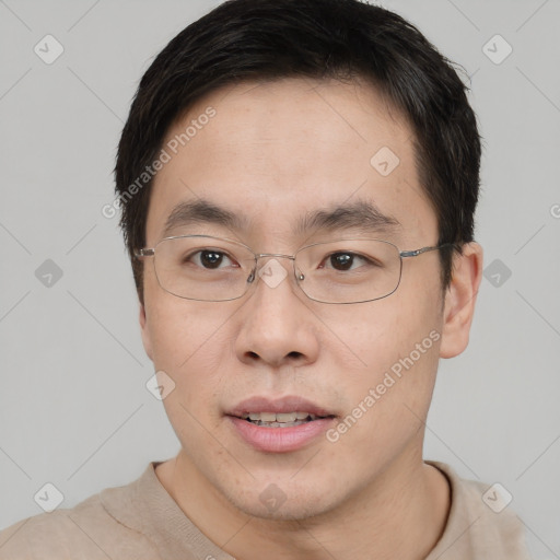 Joyful asian young-adult male with short  brown hair and brown eyes