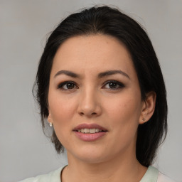 Joyful latino young-adult female with medium  brown hair and brown eyes