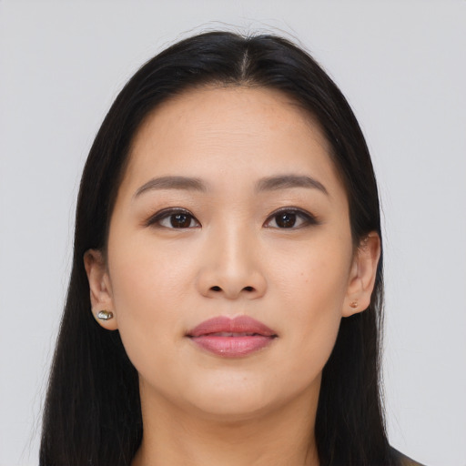 Joyful asian young-adult female with long  brown hair and brown eyes