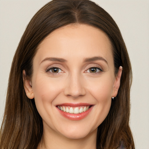 Joyful white young-adult female with long  brown hair and brown eyes