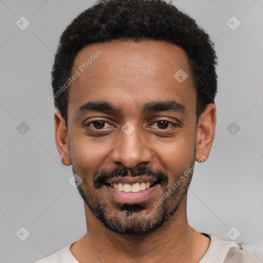 Joyful black young-adult male with short  black hair and brown eyes