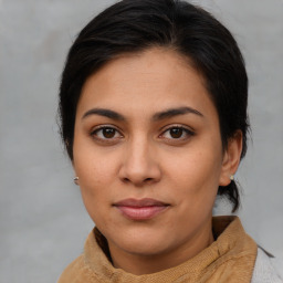 Joyful latino young-adult female with medium  brown hair and brown eyes