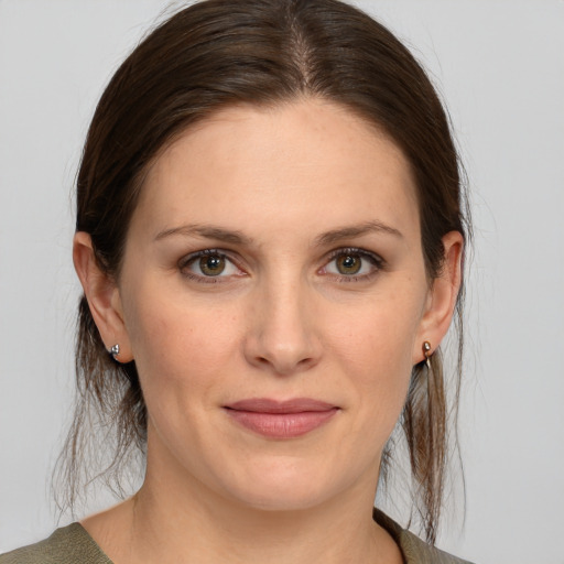 Joyful white young-adult female with medium  brown hair and brown eyes