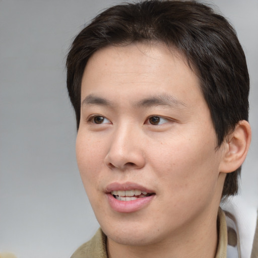 Joyful white young-adult male with medium  brown hair and brown eyes