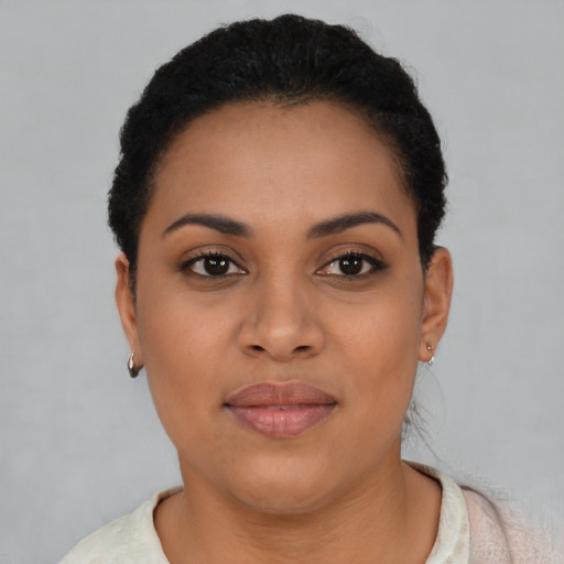Joyful black young-adult female with short  brown hair and brown eyes