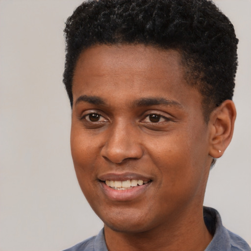 Joyful black young-adult male with short  black hair and brown eyes