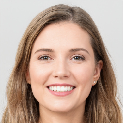 Joyful white young-adult female with long  brown hair and grey eyes