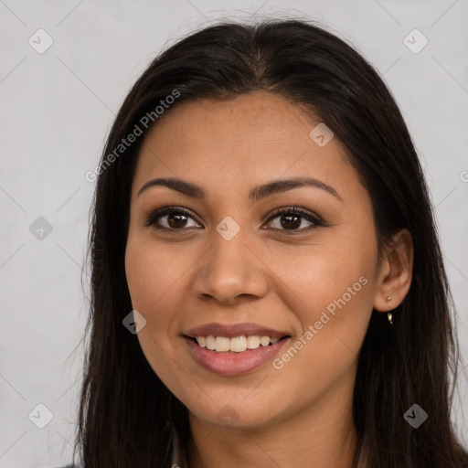 Joyful latino young-adult female with long  brown hair and brown eyes