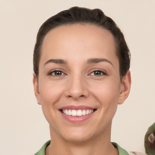 Joyful white young-adult female with short  brown hair and brown eyes