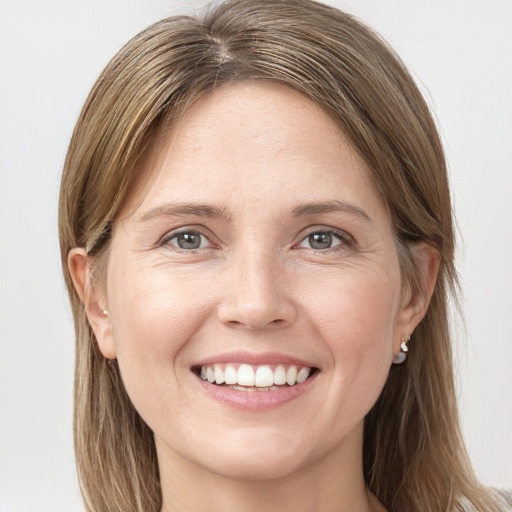 Joyful white young-adult female with long  brown hair and grey eyes