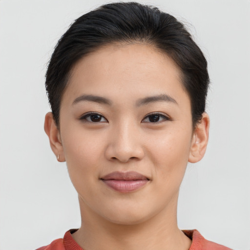 Joyful asian young-adult female with short  brown hair and brown eyes