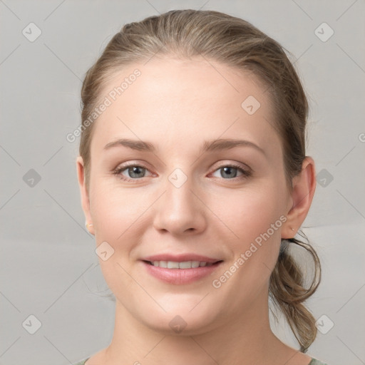 Joyful white young-adult female with medium  brown hair and grey eyes