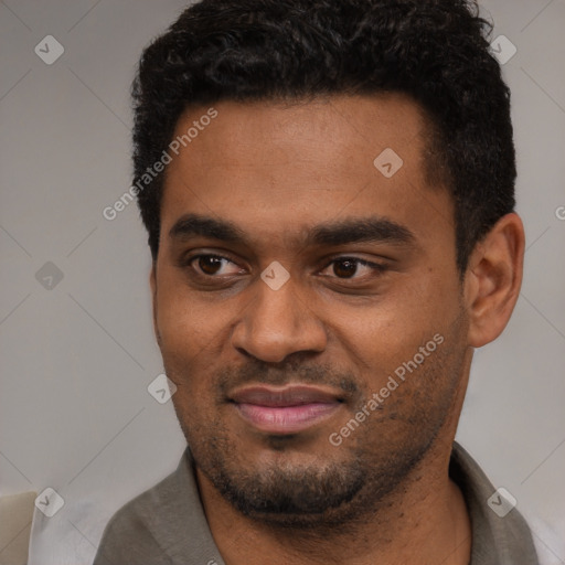 Joyful black young-adult male with short  black hair and brown eyes