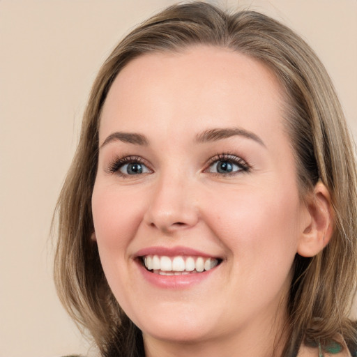 Joyful white young-adult female with long  brown hair and green eyes