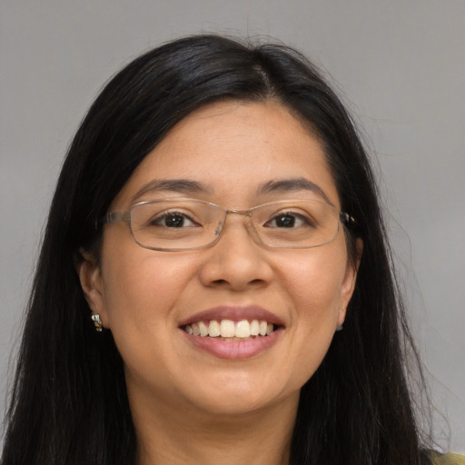 Joyful asian young-adult female with long  brown hair and brown eyes