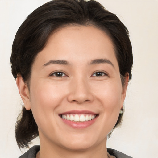 Joyful white young-adult female with medium  brown hair and brown eyes