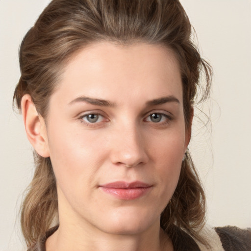 Joyful white young-adult female with medium  brown hair and grey eyes