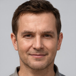 Joyful white adult male with short  brown hair and brown eyes