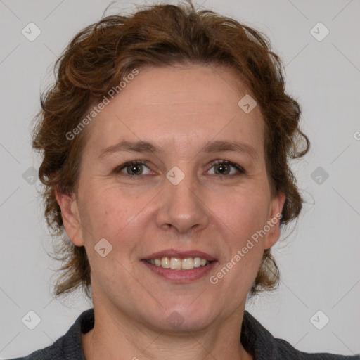 Joyful white adult female with medium  brown hair and blue eyes