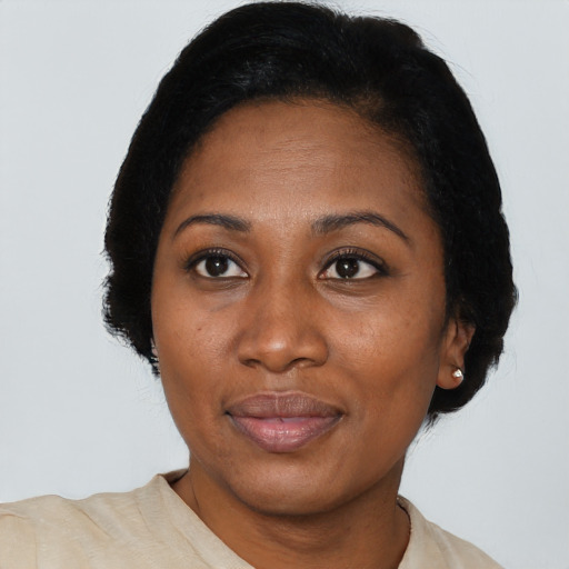 Joyful black adult female with short  black hair and brown eyes