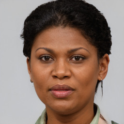 Joyful black adult female with short  brown hair and brown eyes