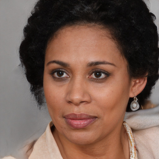 Joyful latino adult female with short  brown hair and brown eyes