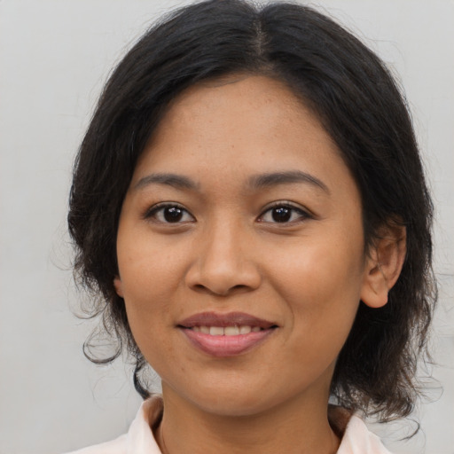 Joyful asian young-adult female with medium  brown hair and brown eyes