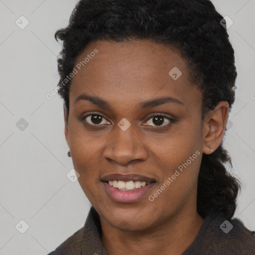 Joyful black young-adult female with short  black hair and brown eyes