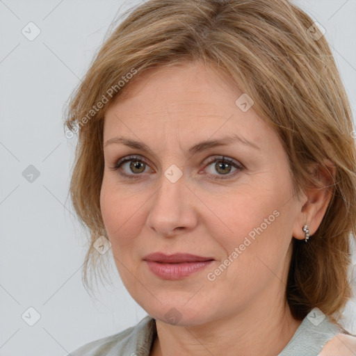 Joyful white adult female with medium  brown hair and blue eyes