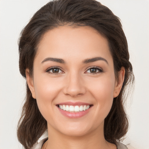 Joyful white young-adult female with medium  brown hair and brown eyes