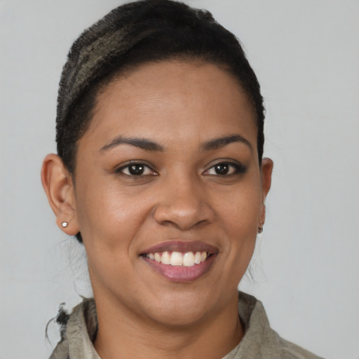 Joyful black young-adult female with short  brown hair and brown eyes