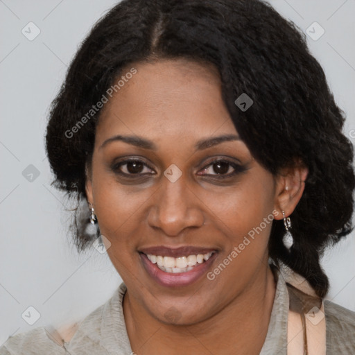 Joyful black adult female with medium  black hair and brown eyes