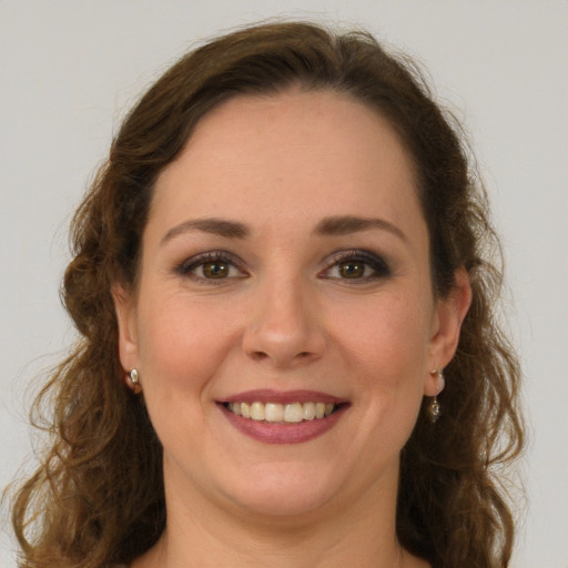 Joyful white young-adult female with long  brown hair and green eyes