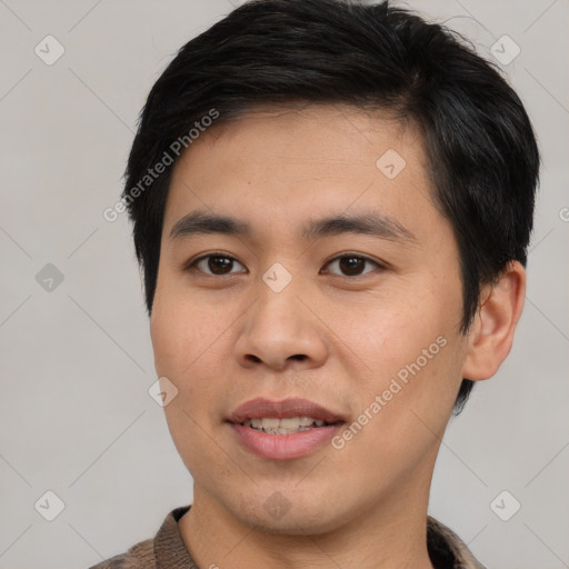 Joyful asian young-adult male with short  black hair and brown eyes