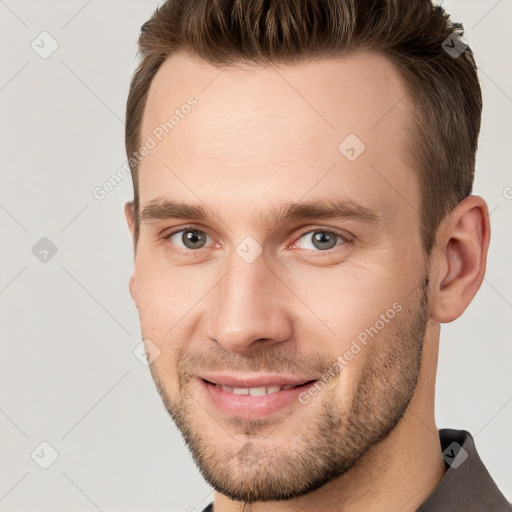 Joyful white young-adult male with short  brown hair and brown eyes