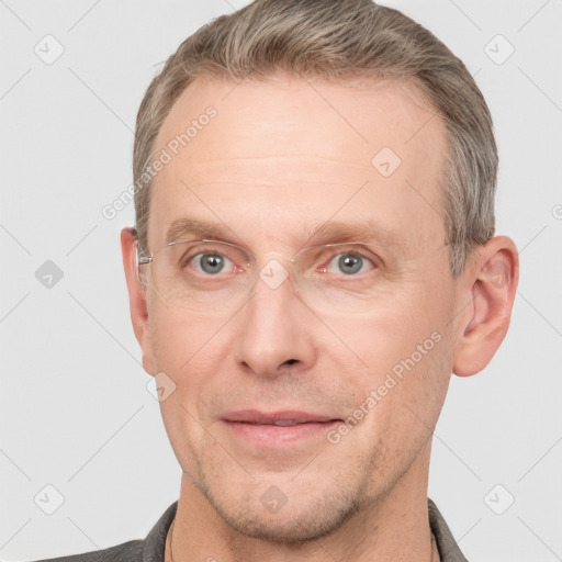 Joyful white adult male with short  brown hair and grey eyes