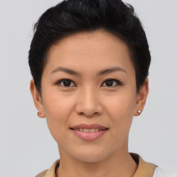 Joyful asian young-adult female with short  brown hair and brown eyes