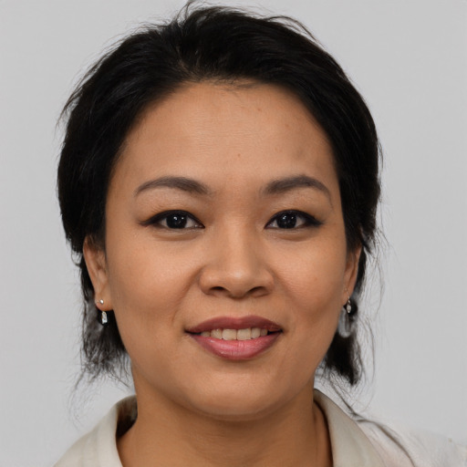 Joyful asian young-adult female with medium  black hair and brown eyes