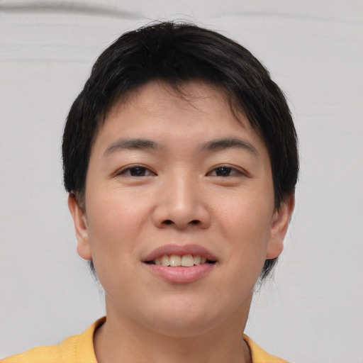 Joyful asian young-adult male with short  brown hair and brown eyes