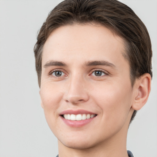 Joyful white young-adult female with short  brown hair and grey eyes