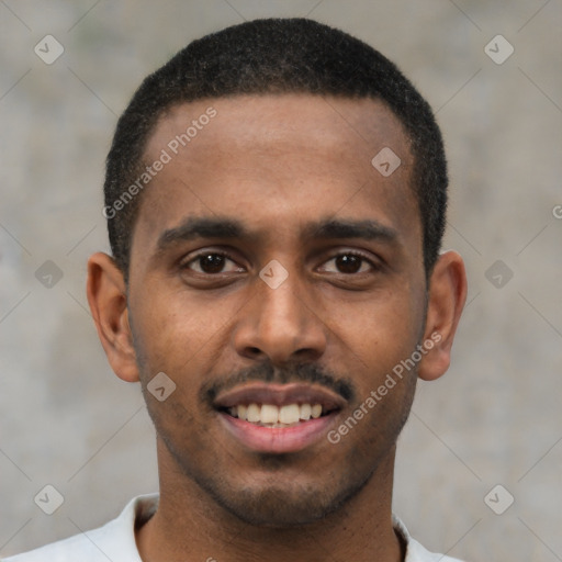 Joyful black young-adult male with short  black hair and brown eyes