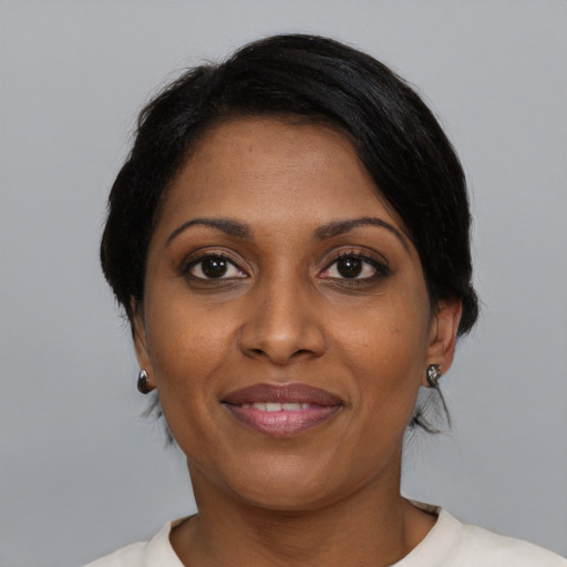 Joyful black adult female with medium  black hair and brown eyes